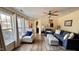 Cozy living room with lots of natural light, blue sofas, and neutral walls at 404 Braxman Ln, Holly Springs, NC 27540