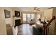 Bright living room boasts a fireplace, large windows, and stylish, neutral-toned furnishings at 404 Braxman Ln, Holly Springs, NC 27540