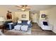 Inviting living room featuring a ceiling fan, neutral walls, and comfortable blue furnishings at 404 Braxman Ln, Holly Springs, NC 27540