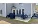 Back patio featuring an outdoor dining set and access to a gray home at 404 Braxman Ln, Holly Springs, NC 27540