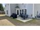 Cozy patio with outdoor dining set, grill, and access to the home at 404 Braxman Ln, Holly Springs, NC 27540