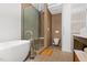 Contemporary bathroom with soaking tub, glass-enclosed shower, and modern toilet at 407A Hillsborough St, Chapel Hill, NC 27514