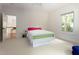 Cozy bedroom featuring a brightly decorated bed, neutral carpet and ample natural light at 407A Hillsborough St, Chapel Hill, NC 27514