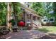Charming two-story yellow home with a brick porch and a unique red apple sculpture at 407A Hillsborough St, Chapel Hill, NC 27514