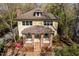 Charming yellow home with brick porch and manicured landscaping offers classic curb appeal at 407A Hillsborough St, Chapel Hill, NC 27514