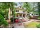 Lovely two-story yellow home with brick porch, lush trees, and unique red apple sculpture at 407A Hillsborough St, Chapel Hill, NC 27514