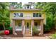 Delightful yellow home with a brick porch, white railings, and manicured landscape features classic elegance at 407A Hillsborough St, Chapel Hill, NC 27514