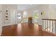 Open hallway with hardwood floors, white railings and multiple art paintings at 407A Hillsborough St, Chapel Hill, NC 27514