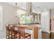 Bright modern kitchen with stainless steel appliances and wooden breakfast bar seating at 407A Hillsborough St, Chapel Hill, NC 27514
