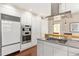 Sleek modern kitchen with stainless steel appliances, white cabinets, and a gas range at 407A Hillsborough St, Chapel Hill, NC 27514