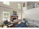 Bright, two-story living room with fireplace, comfortable furniture, and lots of natural light at 407A Hillsborough St, Chapel Hill, NC 27514