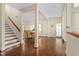 Bright living space featuring hardwood floors, staircase, and open doorway to dining area at 407A Hillsborough St, Chapel Hill, NC 27514