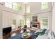 Spacious living room with fireplace, large windows, comfortable seating, and stylish decor at 407A Hillsborough St, Chapel Hill, NC 27514