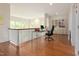 Upstairs office space with hardwood floors, built-in shelving, and a glass desk at 407A Hillsborough St, Chapel Hill, NC 27514