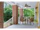 Inviting porch with a ceiling fan, outdoor seating, and a tranquil view of trees at 407A Hillsborough St, Chapel Hill, NC 27514