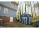 Backyard featuring blue shed and home exterior at 410 N Currie Dr, Sanford, NC 27330