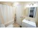 Bright bathroom features a shower-tub combination, vanity, and ample lighting at 410 N Currie Dr, Sanford, NC 27330