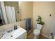 Bright bathroom featuring a white sink, toilet, and bathtub with neutral wall color at 410 N Currie Dr, Sanford, NC 27330