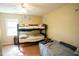Cozy bedroom with a bunk bed, twin bed, and lots of natural light at 410 N Currie Dr, Sanford, NC 27330