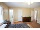 Bedroom with tan walls, a ceiling fan and wood-look flooring, and dresser at 410 N Currie Dr, Sanford, NC 27330