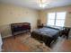 Bedroom featuring a double bed, crib, and lots of natural light at 410 N Currie Dr, Sanford, NC 27330