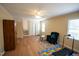 Spacious bonus room with wood-look floors and a view to the stairwell at 410 N Currie Dr, Sanford, NC 27330