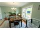 Bright dining room features hardwood floors, a chandelier, and a large window with natural light at 410 N Currie Dr, Sanford, NC 27330