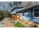 Charming exterior with brick accents, stone walkway, and a well-manicured yard at 410 N Currie Dr, Sanford, NC 27330