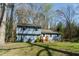 Two-story home with a well-maintained lawn and mature trees at 410 N Currie Dr, Sanford, NC 27330