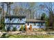 Charming blue two-story home featuring a brick walkway and landscaped front yard at 410 N Currie Dr, Sanford, NC 27330