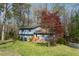 Charming two-story home with a well-maintained lawn and mature trees at 410 N Currie Dr, Sanford, NC 27330