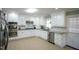 Bright kitchen featuring white cabinetry, stainless steel appliances, and granite countertops at 410 N Currie Dr, Sanford, NC 27330