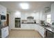 Bright kitchen featuring white cabinetry, stainless steel appliances, and granite countertops at 410 N Currie Dr, Sanford, NC 27330