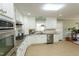 Bright kitchen with modern appliances, white cabinetry, granite countertops, and tile backsplash at 410 N Currie Dr, Sanford, NC 27330