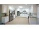 Spacious kitchen featuring white cabinetry, stainless steel appliances, and lots of counter space at 410 N Currie Dr, Sanford, NC 27330