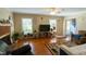 Cozy living room with fireplace, plants, large windows and view to blue front door at 410 N Currie Dr, Sanford, NC 27330