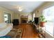 Bright living room with fireplace, ceiling fan, hardwood floors and large windows at 410 N Currie Dr, Sanford, NC 27330