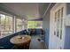 Cozy sunroom with multiple windows, tiled floors and comfortable seating at 410 N Currie Dr, Sanford, NC 27330