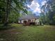 Scenic view of the home's backyard, complete with a deck and lush greenery at 4116 Tall Pine Dr, Franklinton, NC 27525