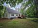 Rear exterior view showcasing the home's deck and peaceful wooded setting at 4116 Tall Pine Dr, Franklinton, NC 27525