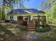 Charming backyard deck, ideal for outdoor relaxation and entertainment, with stairs leading to a well-manicured lawn at 4116 Tall Pine Dr, Franklinton, NC 27525