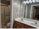 Bathroom featuring a double sink vanity and shower with glass door at 4116 Tall Pine Dr, Franklinton, NC 27525