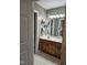 Bathroom features a double sink vanity with tiled floors and storage at 4116 Tall Pine Dr, Franklinton, NC 27525