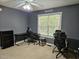 Bedroom with gray walls, large window, and space for two desks at 4116 Tall Pine Dr, Franklinton, NC 27525