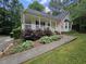 Inviting home with a welcoming front porch, attractive landscaping, and a walkway to the entrance at 4116 Tall Pine Dr, Franklinton, NC 27525