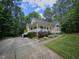 Charming home with a covered porch, landscaped yard, and inviting curb appeal nestled among the trees at 4116 Tall Pine Dr, Franklinton, NC 27525