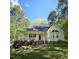 Inviting home with a classic front porch, bay window, and beautifully landscaped yard, all nestled among mature trees at 4116 Tall Pine Dr, Franklinton, NC 27525