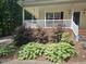 Well-maintained front yard with shrubs and a covered porch at 4116 Tall Pine Dr, Franklinton, NC 27525