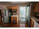 Galley kitchen features stainless steel refrigerator and a door to the outdoor porch at 4116 Tall Pine Dr, Franklinton, NC 27525