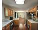 Spacious kitchen with wood floors, stainless steel refrigerator, and open access to dining area at 4116 Tall Pine Dr, Franklinton, NC 27525
